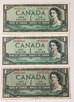 Front view of three Canadian one dollar bills showing the portrait of Queen Elizabeth II with serial numbers visible.