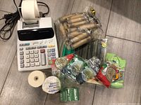 Sharp EL-1801V calculator, calculator paper rolls, wrapped coin wrappers, coin sorting trays and counters on floor