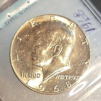 Obverse side of the 1968 USA half dollar showing John F. Kennedy profile and inscriptions.