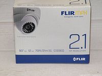 Photo of FLIR C133ED camera original packaging front showing model, resolution 2.1MP, 90° lens, power and night vision range details.