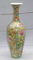 Full view of tall yellow eggshell porcelain vase with hand-painted floral and dragon decoration.