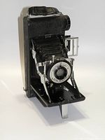 Front three-quarter view of the King Penguin folding camera showing the extended bellows and front lens plate with 'Kershaw eight-20 King Penguin' markings.