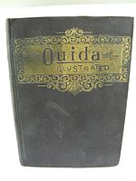 Front cover of the dark cloth hardcover book 'Ouida Illustrated' with ornate gold embossing.