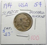 Front side of 1914 Buffalo Indian Head nickel mounted in cardboard holder with handwritten notes.