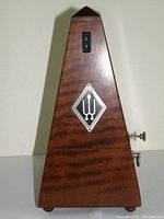 Front view of Wittner wooden metronome showing logo, wood texture, and tempo scale.