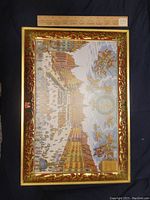 Photo of a large rectangular decorative tin with detailed colorful illustration of a historic Bavarian town with people, buildings, and heraldic designs. Signed E Otto Schmidt, for Nurnberger Lebkuchen, made in Germany.