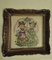 Square porcelain picture with ornate frame and painting of Bavarian children