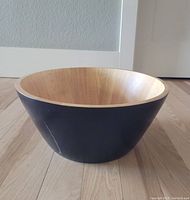 Large wood bowl on wooden floor showing exterior crack and natural wood interior