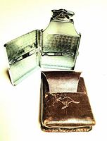 Photo of open silver-tone Ronson metal lighter case and brown leather carrying pouch with kangaroo embossing.