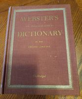 Front cover of Webster's New Twentieth Century Dictionary hardcover book in burgundy with gold text.