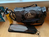 Overall view of carry bag, pump, and paddle laid out on floor