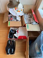 Lot of men's shoes and clothing including two pairs of shoes (Church's leather brogues and Cofra safety shoes), shirts, socks, underwear, and hats packed in boxes and bags.