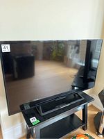 Front view of the Sony Bravia flatscreen TV displaying screen and stand.