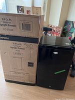 Freezer next to original packing box showing front view