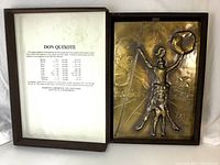 Open wooden box showing felt lining with printed edition details on left and bronze relief plaque on right