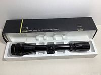 Scope displayed in original Styrofoam insert inside box.