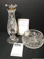 Photo showing both the bud vase and nut bowl together with a Mozart Collection informational booklet behind them.