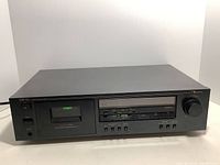 Front view of Nakamichi CR-1A cassette deck showing full unit with buttons and cassette compartment.