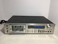 Front angle view of the Pioneer CT-F615 cassette tape deck showing the cassette compartment, control sliders, and power switch on a white surface.