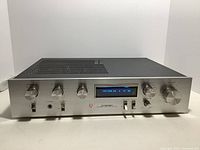 Front view of the Pioneer SA-510 stereo amplifier showing control knobs and blue power meter display.