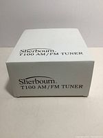 White box labeled Sherbourn T100 AM/FM Tuner, front view.