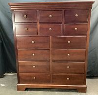 Front view of 14-drawer Stanley Furniture Squire's Chest dresser showing drawer layout, brass knobs, finish and wood tone.