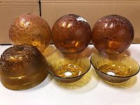 Full set of amber glass shades including 3 round light shades and 3 bowl-shaped floral shades shown together for lot overview.