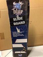 Box label showing Blue Sports Slide Board branding and features such as 6 ft length, non-adjustable, rollable with strap, 2 speed booties, and use for training.
