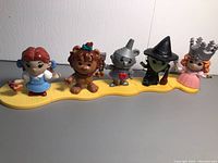 Full set of five Wizard of Oz characters assembled on the yellow path base.