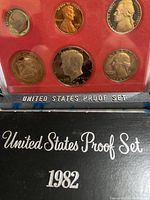 Front view of the 1982-S United States Proof Set showing five proof coins in a plastic case with red background, labeled 'United States Proof Set 1982' on black box.