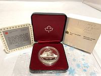 1987 Canadian Silver Proof Dollar coin in black and red presentation box with certificate and original sleeve.