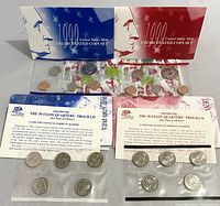 Two sealed 1999 US Mint uncirculated coin sets with envelopes and informational pamphlets for the 50 State Quarters Program.