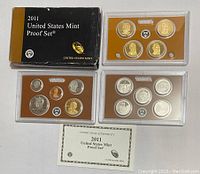 Overview photo showing all three 2011 US coin proof sets in plastic casing and accompanying certificate.