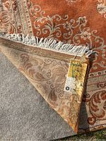 Corner folded to show underside pad and manufacturer tag