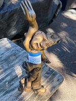 Front view showing main face with an arm raised and a second face near the base