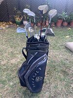 Front view of Nike golf bag filled with golf clubs, showing club heads and bag pockets.
