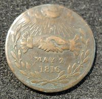 Reverse of coin showing handshake beneath radiant sunburst with laurel wreath and date 'MAY 2 1816'.