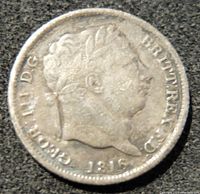 Obverse side of the 1816 silver British six pence coin showing King George III's portrait and date.