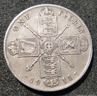Reverse side of the 1911 British One Florin silver coin displaying the heraldic shields and additional inscriptions with the date.