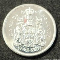 Reverse side of the 1965 Canadian 50 cents silver coin showing the Canadian Coat of Arms with denomination and year.