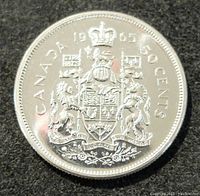 Reverse side showing Canadian coat of arms and denominations.