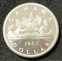 Obverse side of the coin showing the canoe with two men paddling, the year 1965 and 'CANADA DOLLAR' inscription.