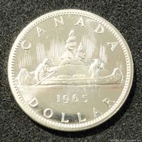 Obverse side of 1965 Canadian silver dollar showing a voyageur canoe with two paddlers and trees.