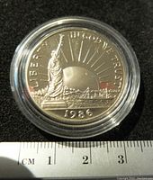 Obverse side of the 1986 USA commemorative half dollar coin showing the Statue of Liberty, dated 1986, with clear and reflective proof finish.