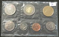 Photo showing front side of one sealed 2001 Canadian coin set with 8 different coins including bi-metallic $2 coin, standard silver tones and copper coins featuring Queen Elizabeth II and Canadian symbols.