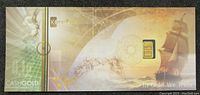 Karatbars banknote with embedded small gold bar and detailed design including a ship and security patterns.