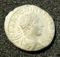 Obverse side of the ancient silver Roman Constantine Antoninianus coin showing the emperor's profile with radiate crown and partial inscriptions.