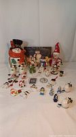 Full collection of various snowmen themed figures and ornaments including cookie jar, trinket box, and wall hanging