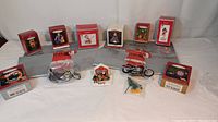 Group photo showing all eleven Hallmark ornaments including two Harley Davidson motorcycles, Barbie, Betty Boop, Santa, Hot Wheels Jet Threat car set, and various boxed ornaments.