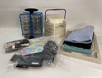 Photo showing rotating bead storage towers, bead organizer box with compartments, assorted bead mats, clear bead design board, and sealed bags of filler beads.